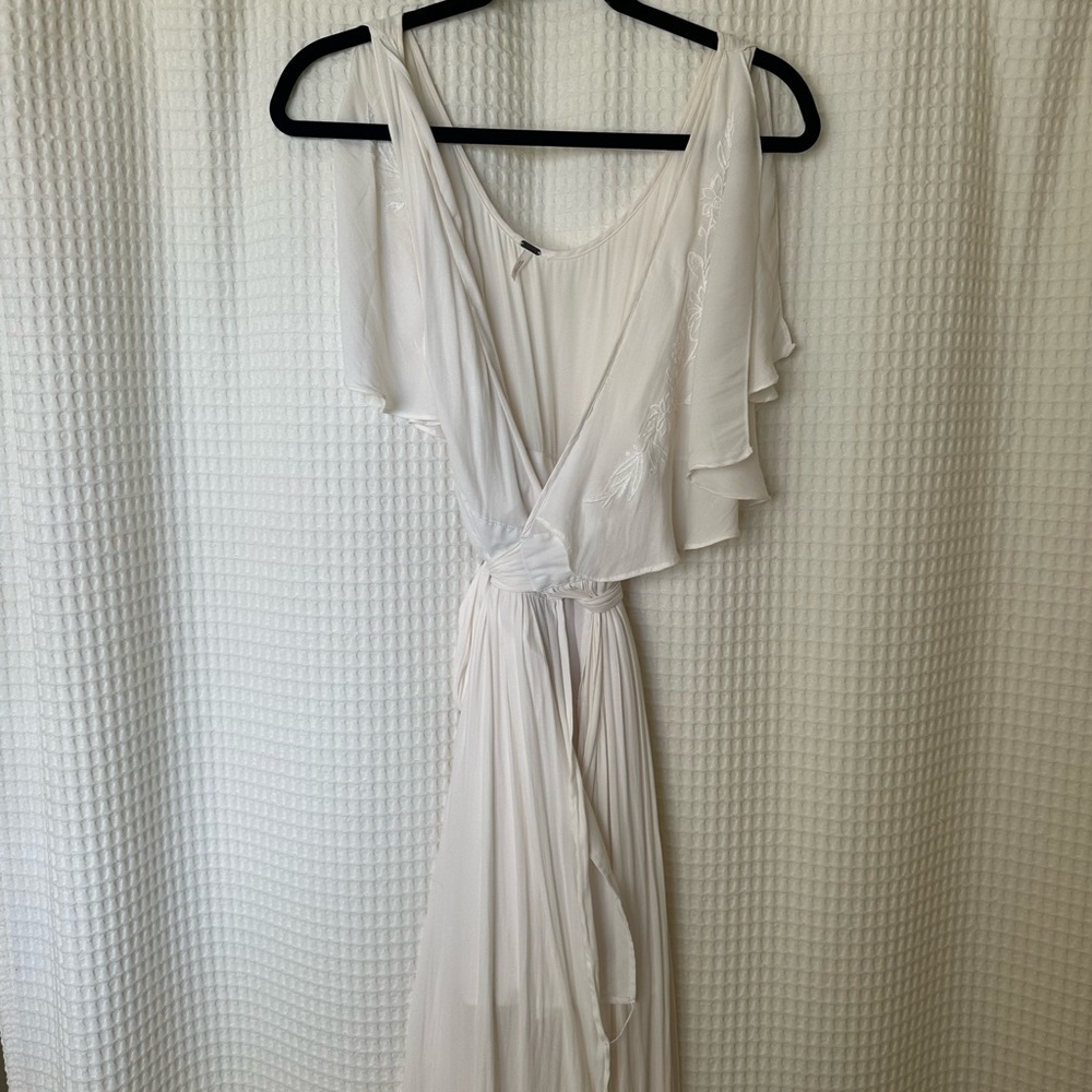 Free people white wrap dress with embroidered detail.